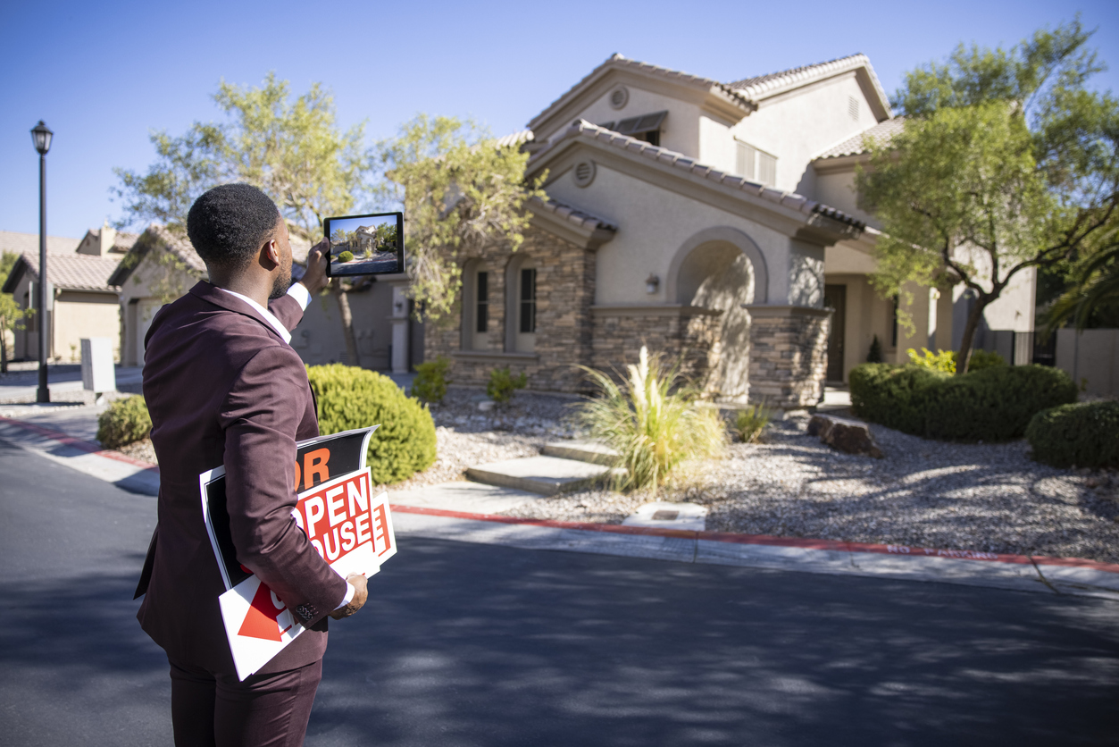 An African American real estate agent getting a house ready for sale.