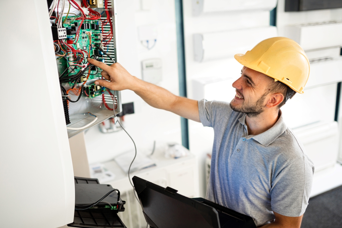 Electrician pointing at electrical panel.