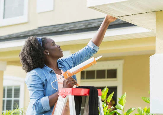 Woman Outside caulking