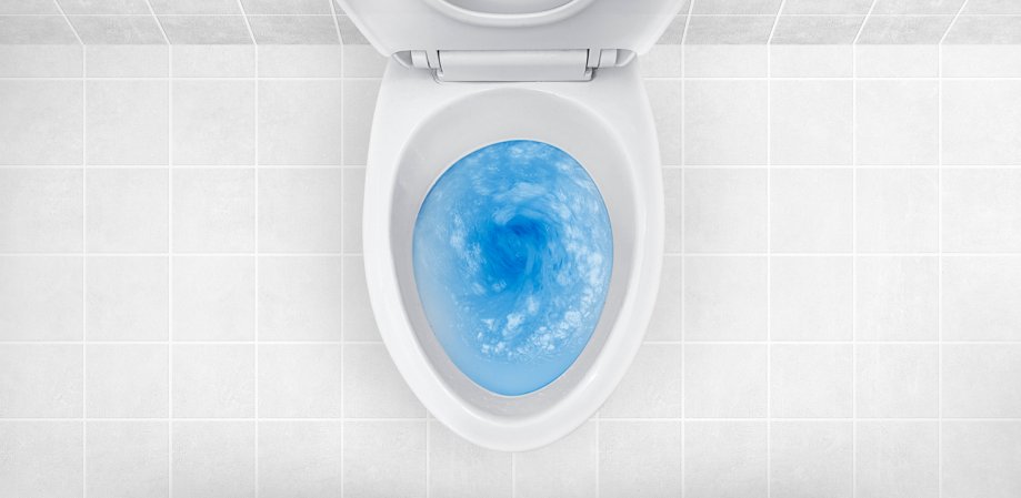 Blue dish soap in a white toilet with the seat up.