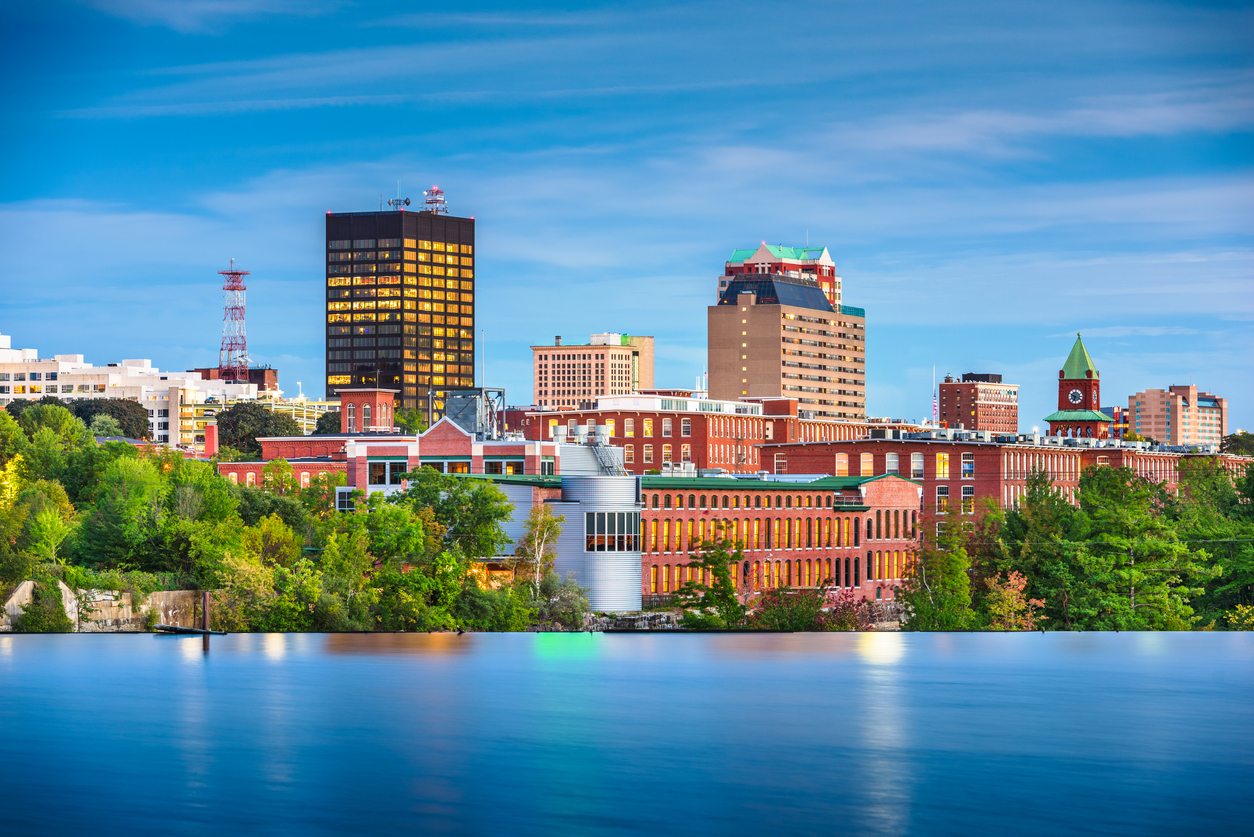 Manchester, New Hampshire, USA Skyline on the Merrimack River at dusk.