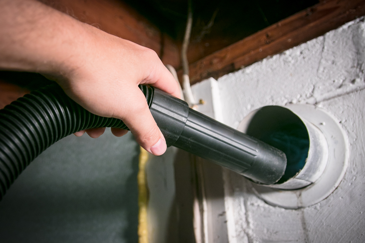 Vacuum cleaning a flexible aluminum dryer vent hose, to remove lint and prevent fire hazard.