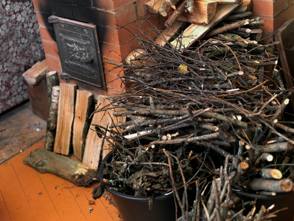 Brushwood next to indoor fireplace.