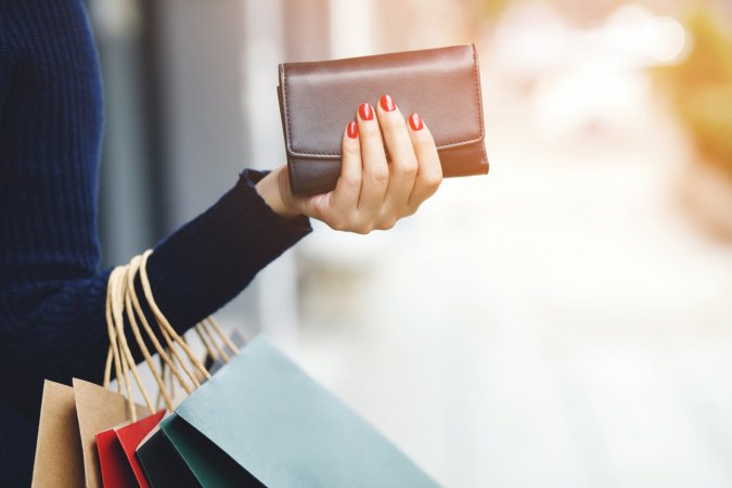 woman person holding a wallet in the hand. Cost control expenses shopping in concept. Leave space to write descriptive text.