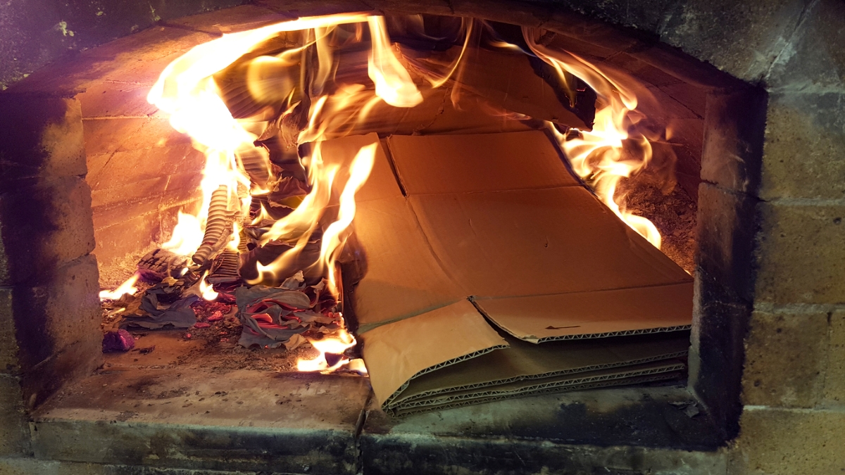 Large cardboard box in fireplace.