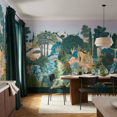 A tropical scene is depicted on a wallpaper mural behind a dining room set.