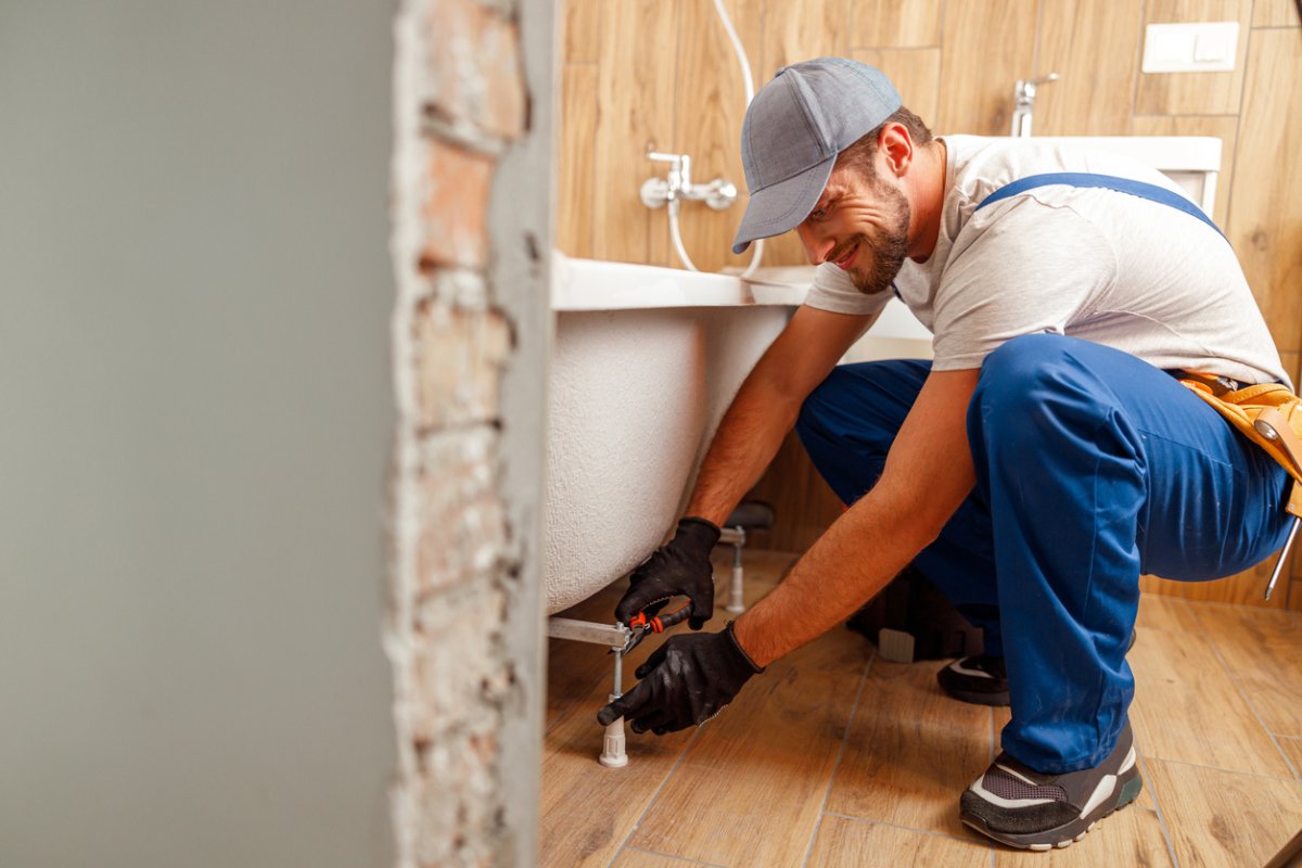 A view of a worker installing a bathtub.