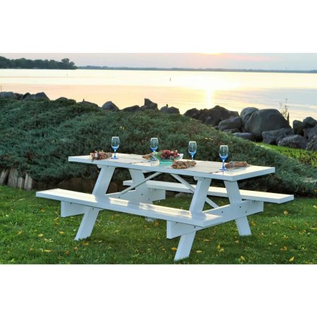  The Dura-Trel 6-Foot White Vinyl Patio Picnic Table set for an upscale picnic at a scenic overlook with a big body of water in the background.