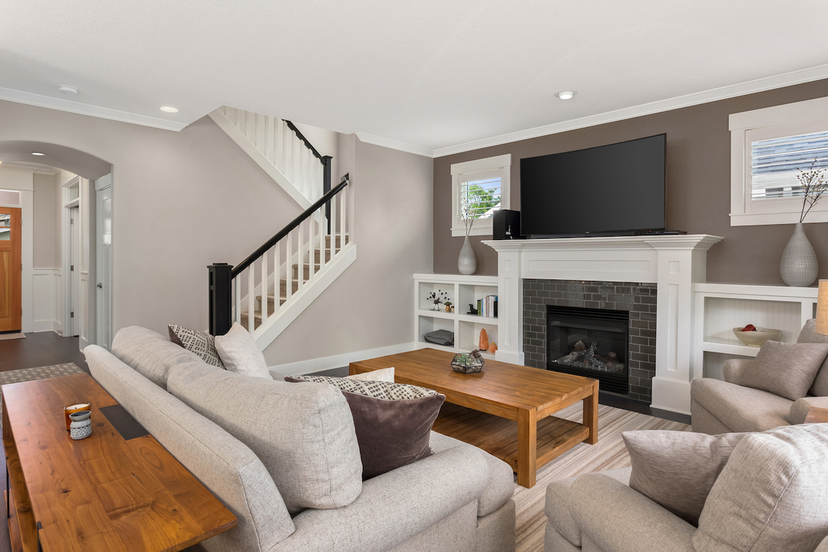 Beautiful living room interior with hardwood floors and fireplace in new luxury home.