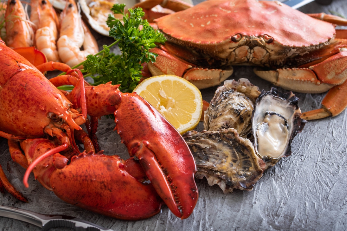 Assorted seafood with lemon slice.