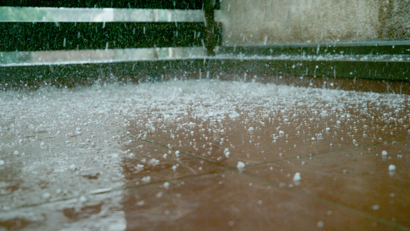 Close up of sleet falling on sidewalk.