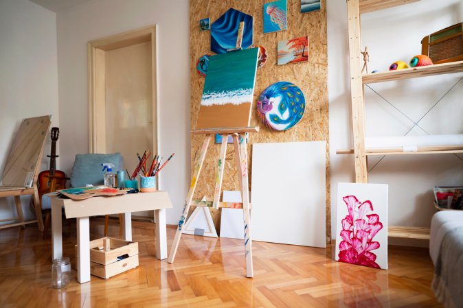 Tidy home art studio with canvas and easel.