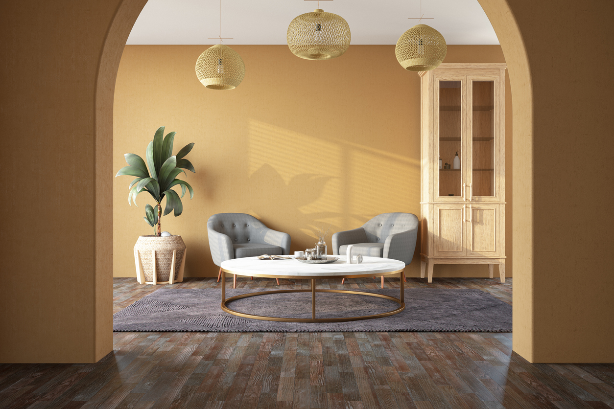 Living room with yellow walls and archway detailed.