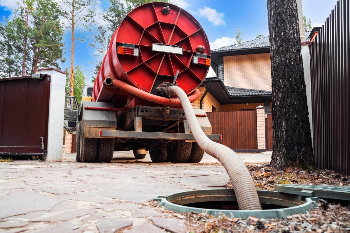 Large red trunk pumping septic system.