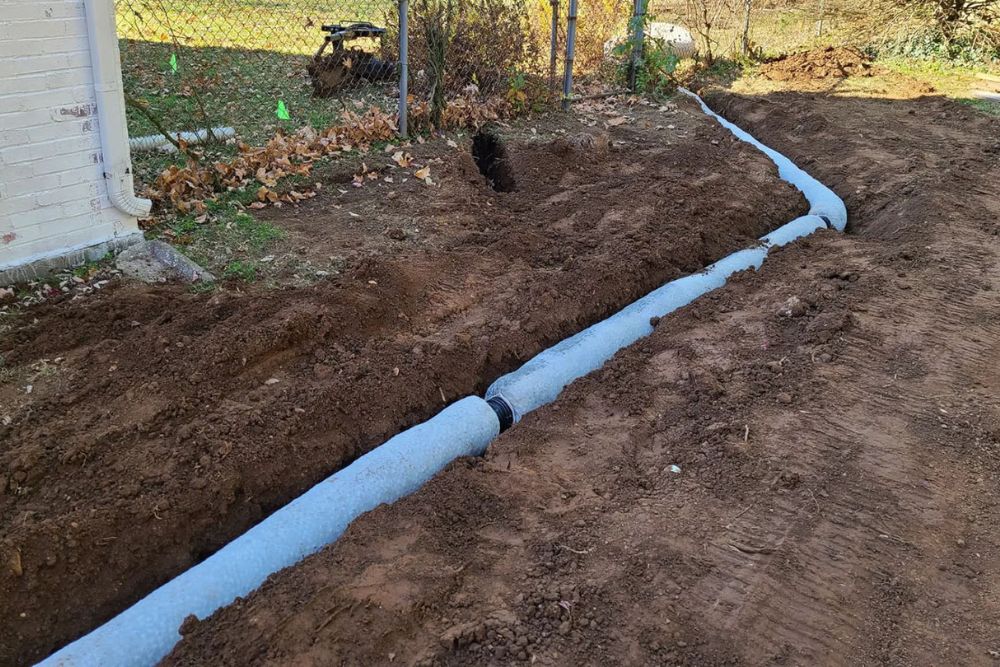 A French drain being installed in a yard.