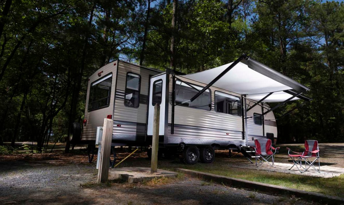 An RV is parked at a campsite at nighttime.