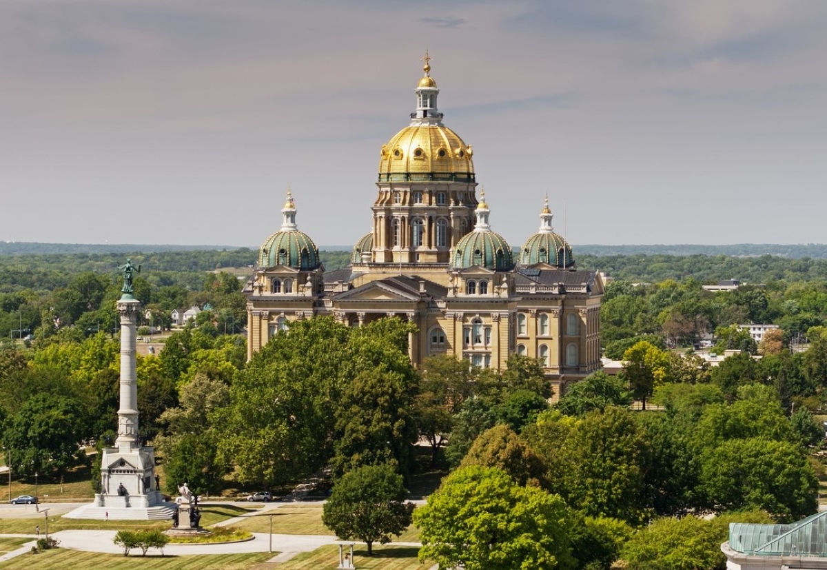 State capitol building among many trees.