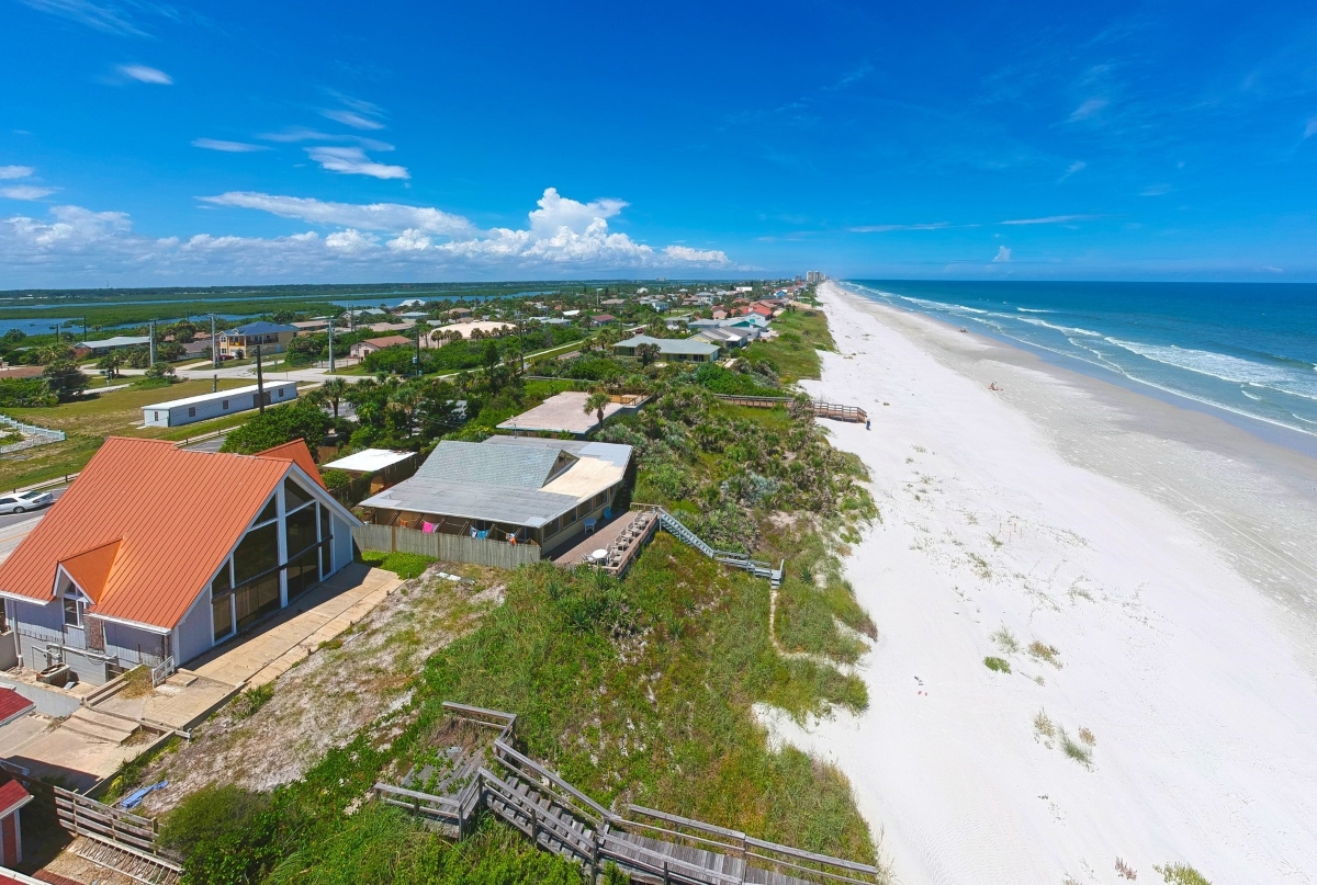 Beach homes along beach and ocean.