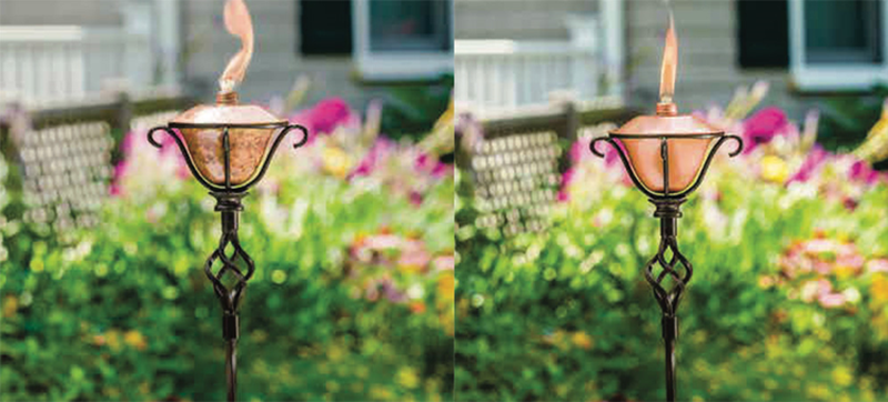 Citronella torches that have been recalled shown lit in a garden surrounding