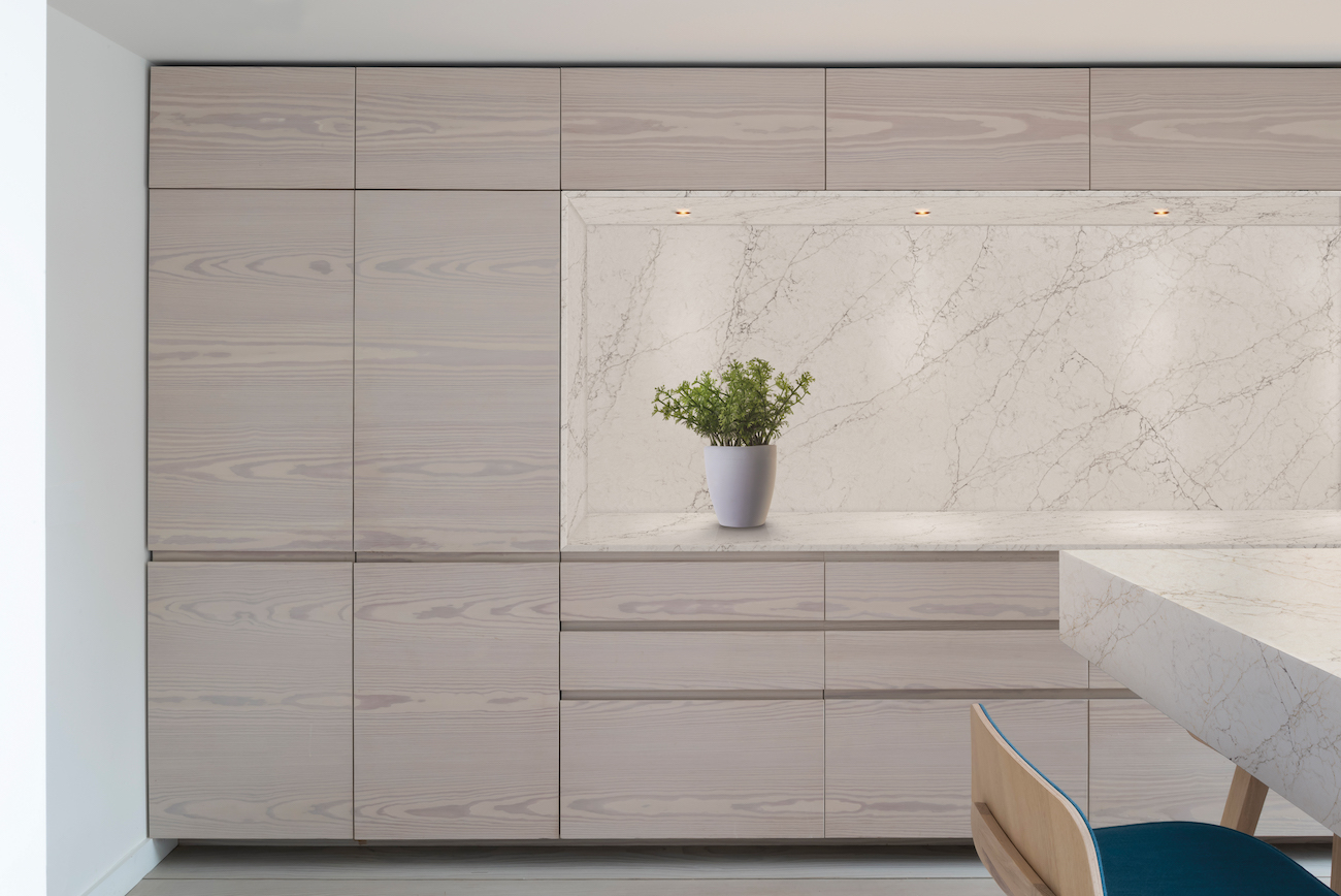 A beige kitchen features a wall of flat front cabinets.