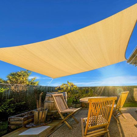  The Artpuch Rectangle Sun Shade Sail protecting an outdoor seating area from sun.