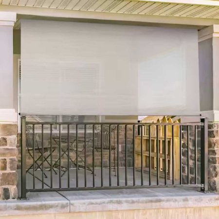  The SeaSun Motorized Outdoor Patio Roller Shade installed at the perimeter of a porch to provide shade and privacy.