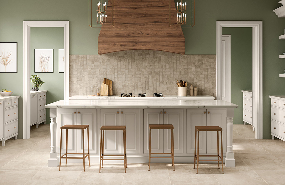 A custom wood finished range hood in a sage green and tile themed kitchen.