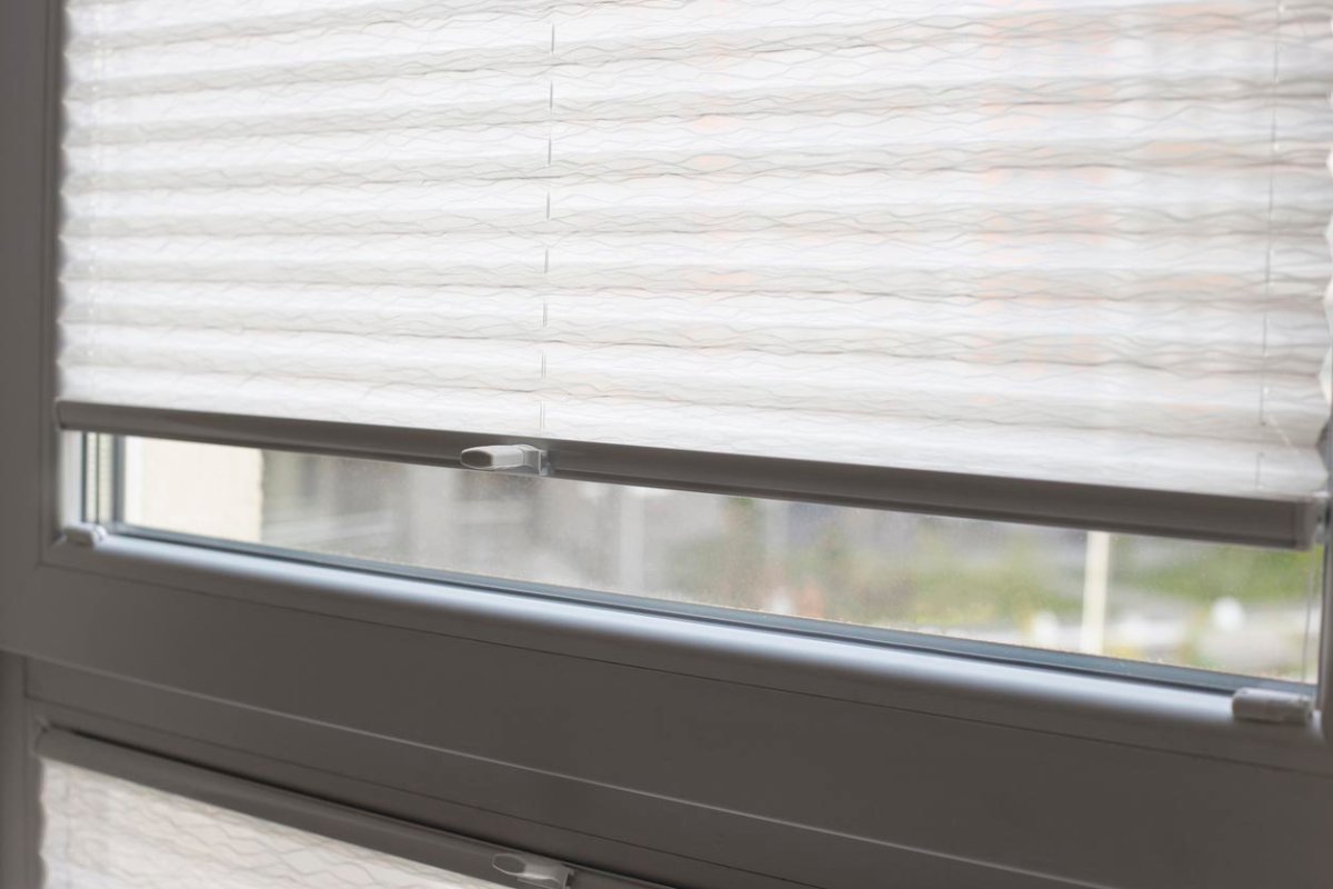 A close up of a window with the blinds pulled down. 