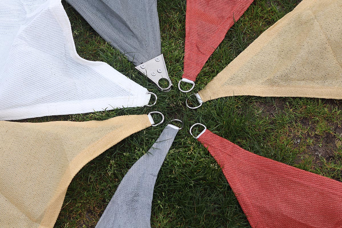 Colorful corners of the best shade sails on a lawn before testing.