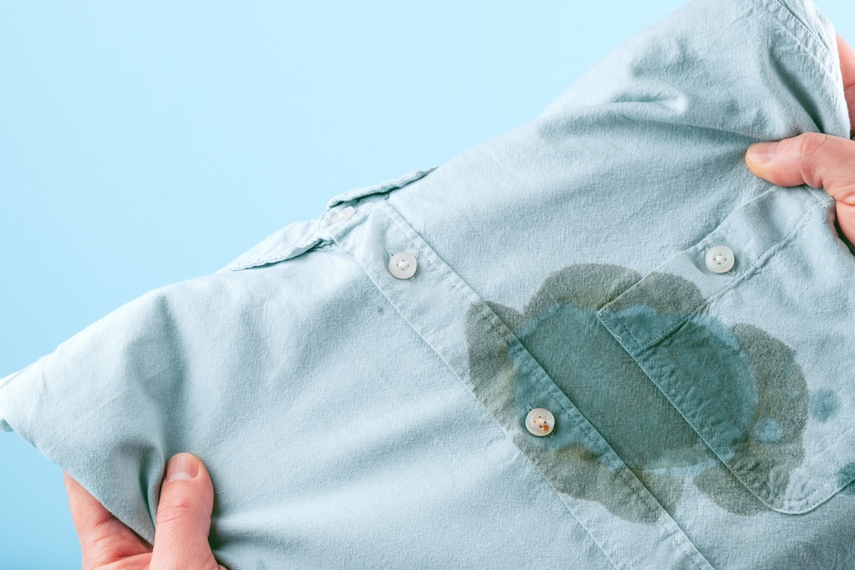 A blue button-down shirt with a grease stain on the chest.