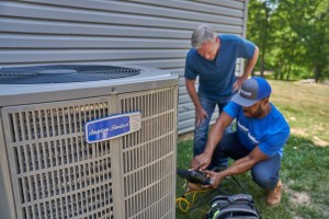 A homeowner with an American Standard HVAC professional asking and answering questions about air-source heat pumps and installing one.