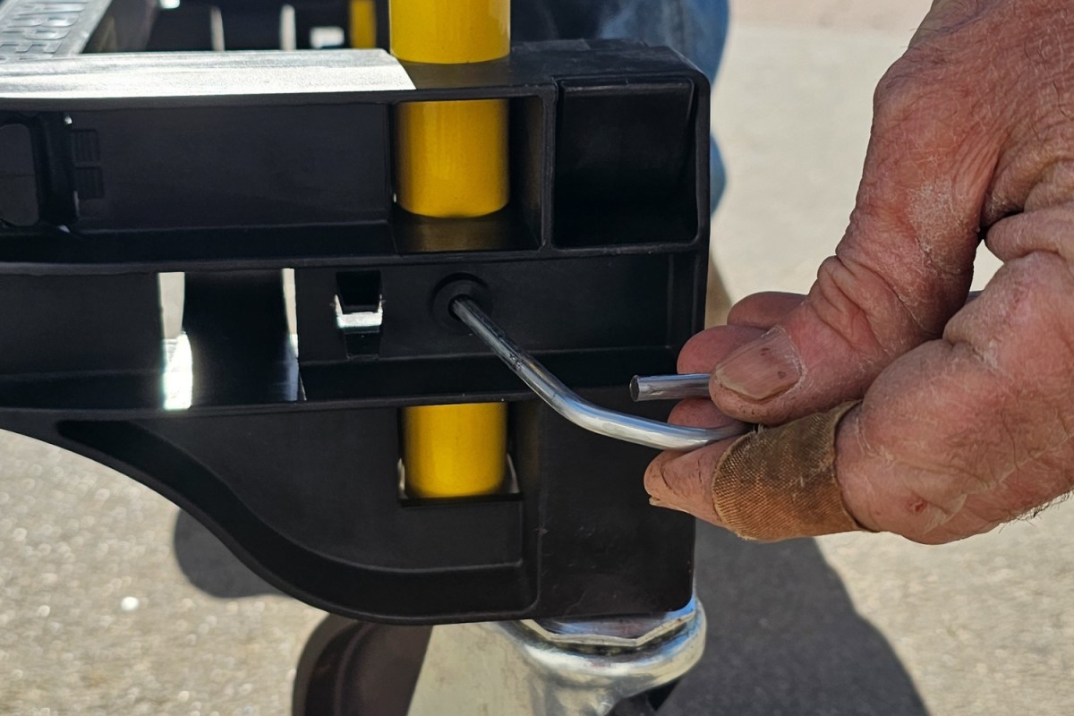 A person locking the Harper Convertible Hand Truck in place during testing.