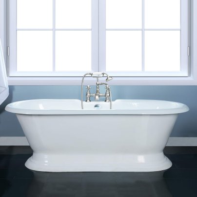 The Kingston Brass Aqua Eden Cast Iron Pedestal Tub in front of a window.