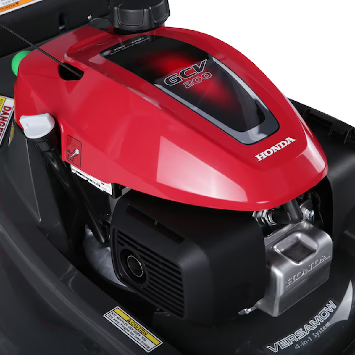 A red Honda mower engine is shown close up.