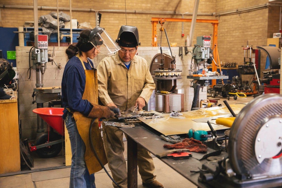 Two welders in a workshop.