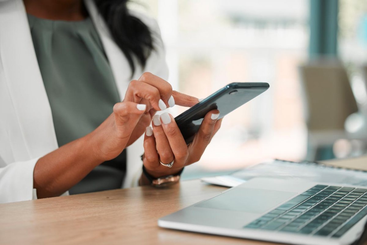 A woman scrolls on her phone. 