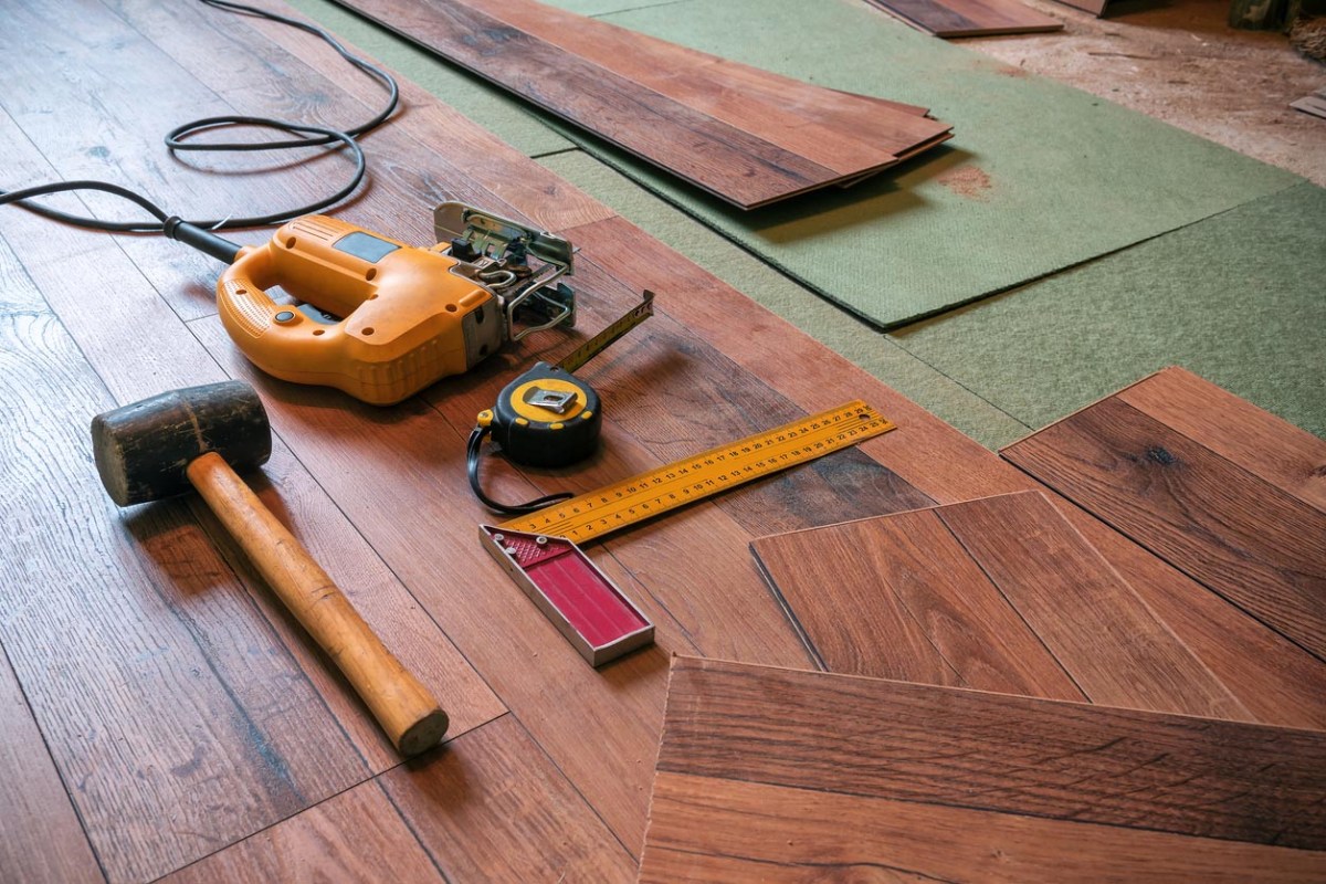 A close up of tools used during a flooring project.