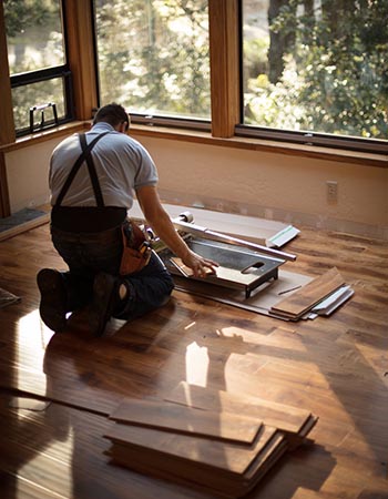 A worker in the process of redoing floors. 