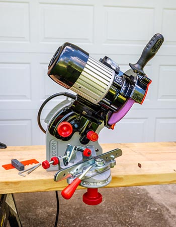 The Oregon 410-120 Bench Grinder Chain Sharpener mounted to a board during testing.