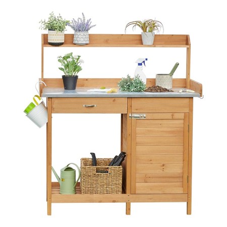 The Yaheetech Garden Potting Bench Table with supplies and plants on a white background.