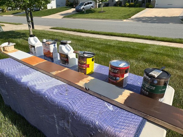 The 6 best solid deck stains next to a stained board during testing.