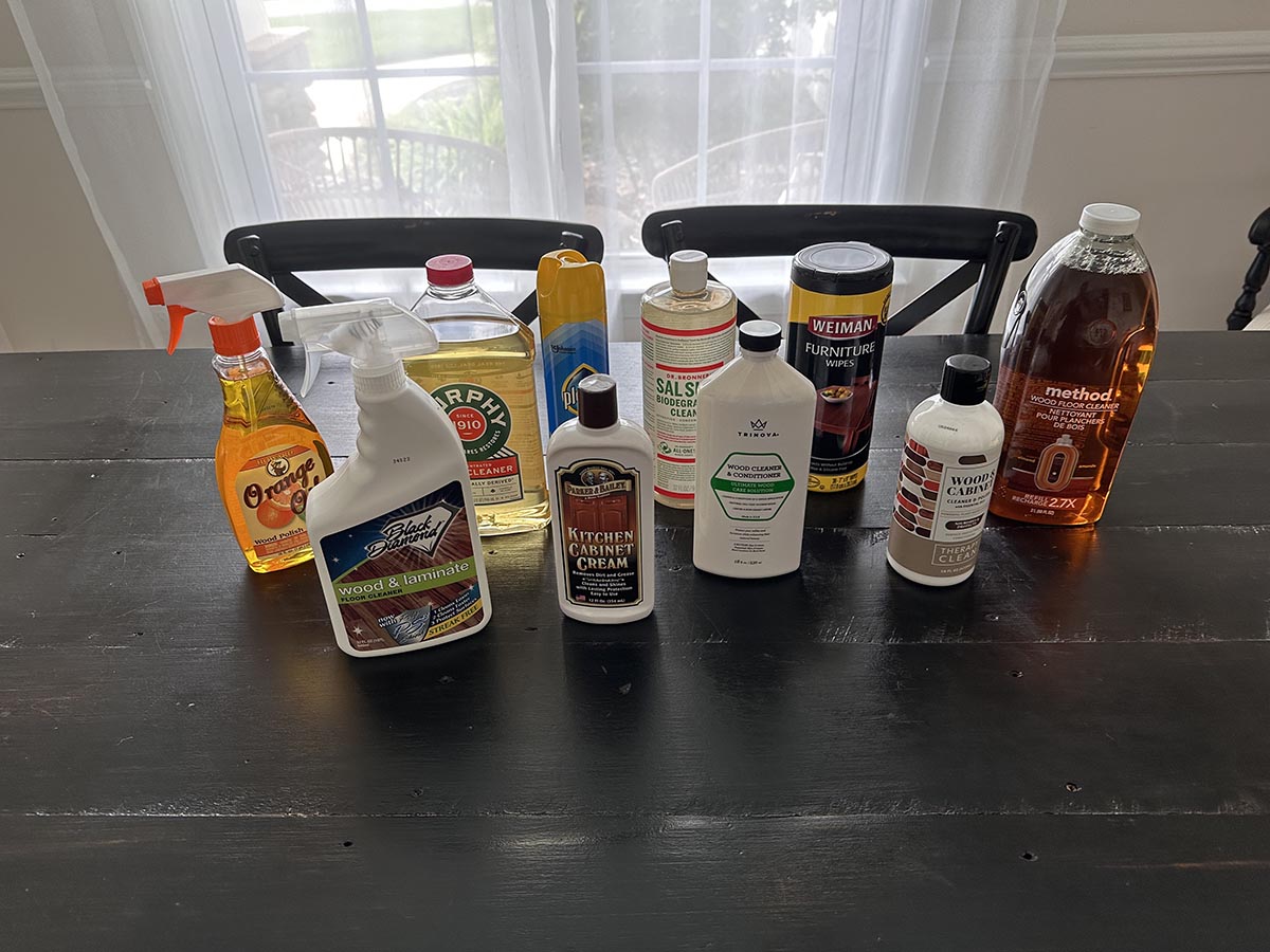 A group of the best wood cleaners on a wood dining table before testing.