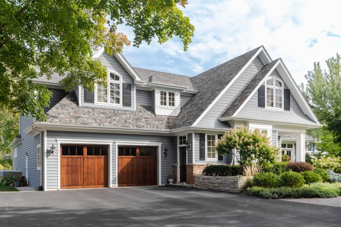 A home with a 2-car garage with wooden doors.