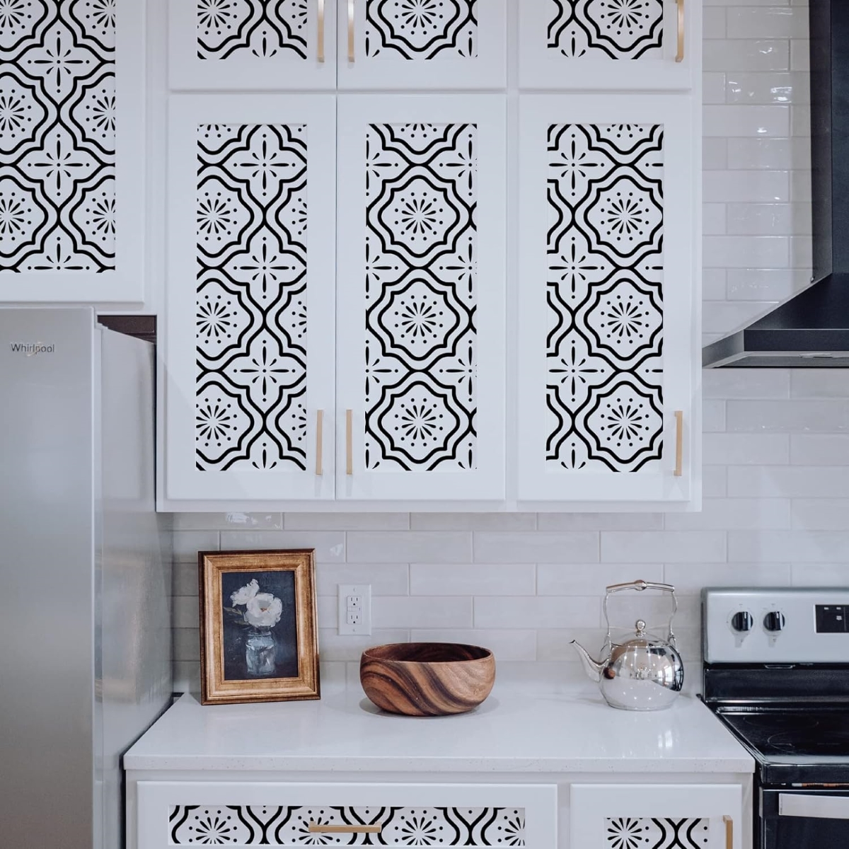 A fun wallpaper is applied to the center of each kitchen cabinet door.