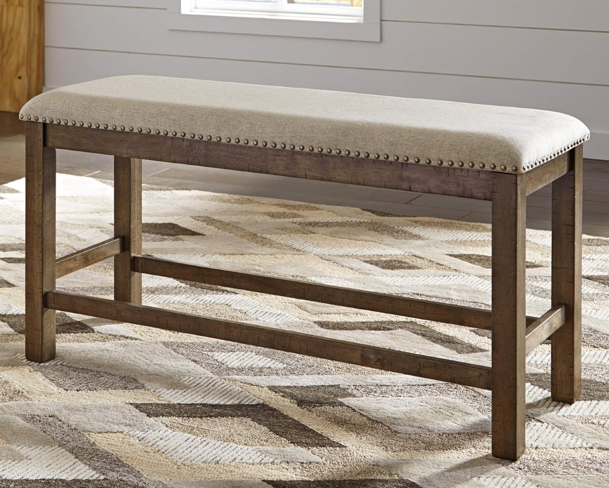 Dining room bench with neutral color upholstered fabric.
