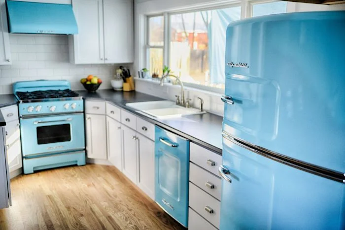A kitchen is set up with blue retro appliances including the Big Chill retro dishwasher.