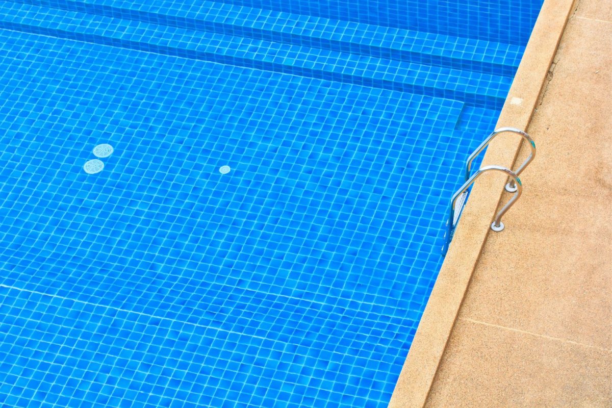 A view of the water in an in ground pool.