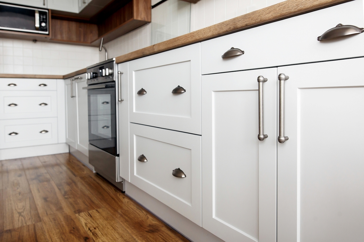 Stylish gray handles installed on kitchen cabinets.