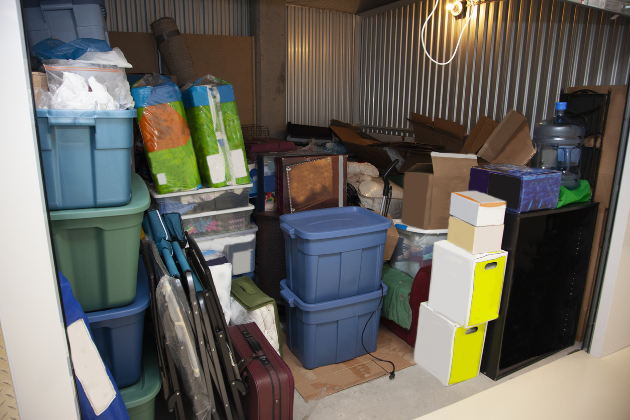 An open storage unit filled with various storage containers and boxes.