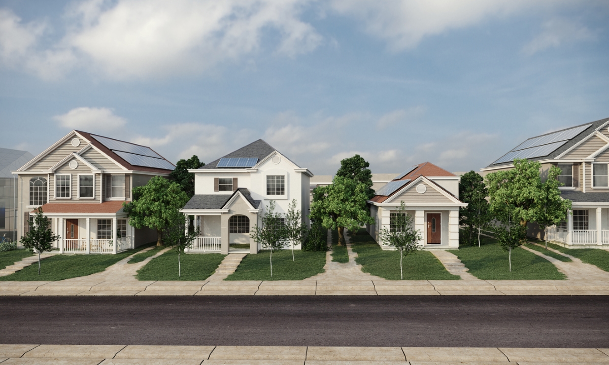 Street view of a neighborhood of homes with solar panels.